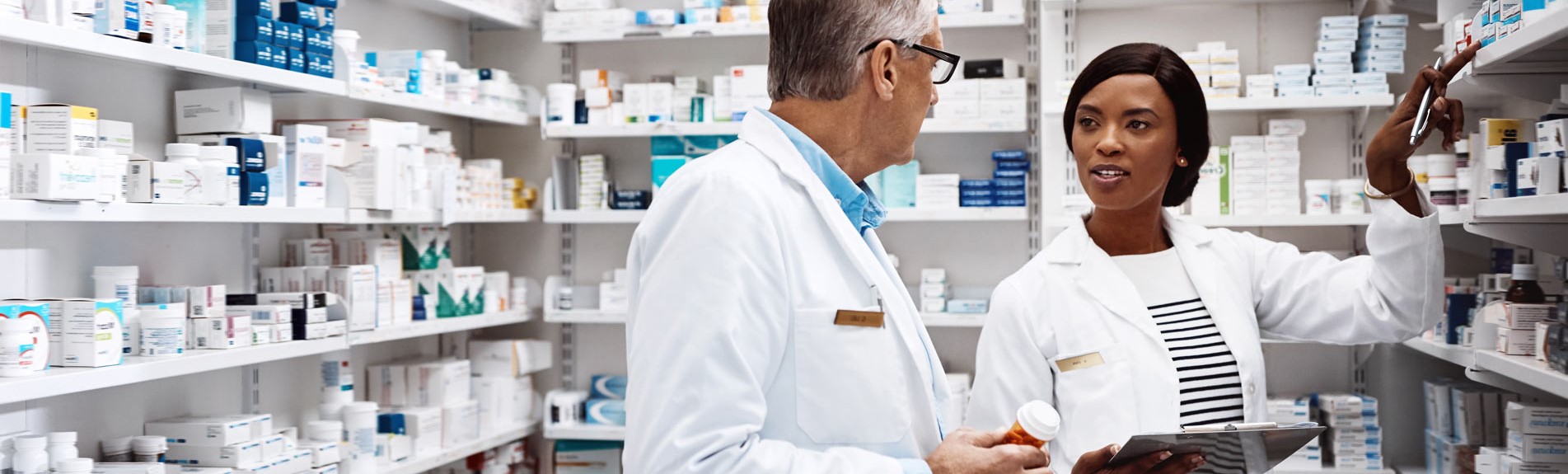 Two Pharmacists Working Together In A Drugstore