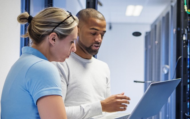 A Duo Of Server Room Technicians Back At The Server Room