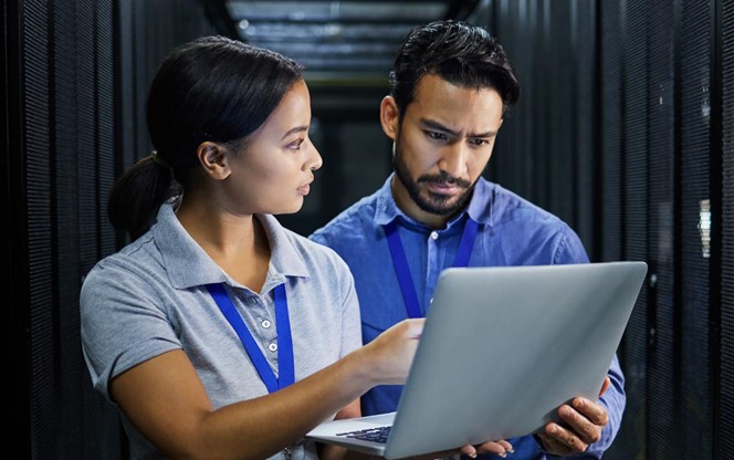 Two data center engineers assessing risk