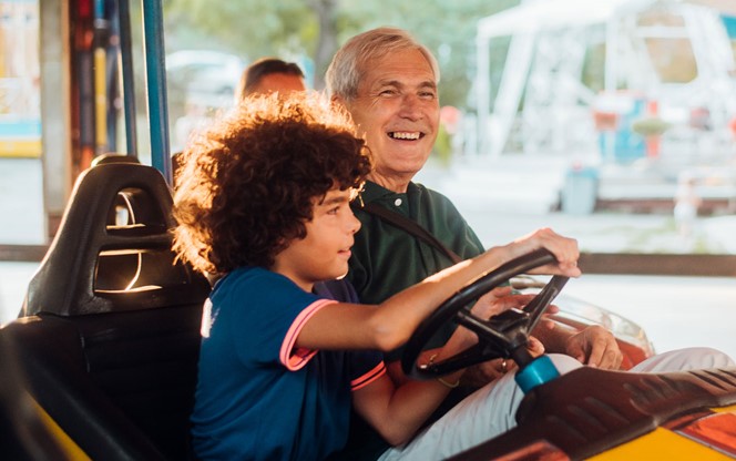 Meaningful Retirement Income Retirement Program Success Grandpa And Grandson In A Bumper Car At The Amusement Park