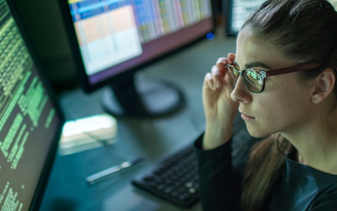 Young Woman Looking At Data On Screen